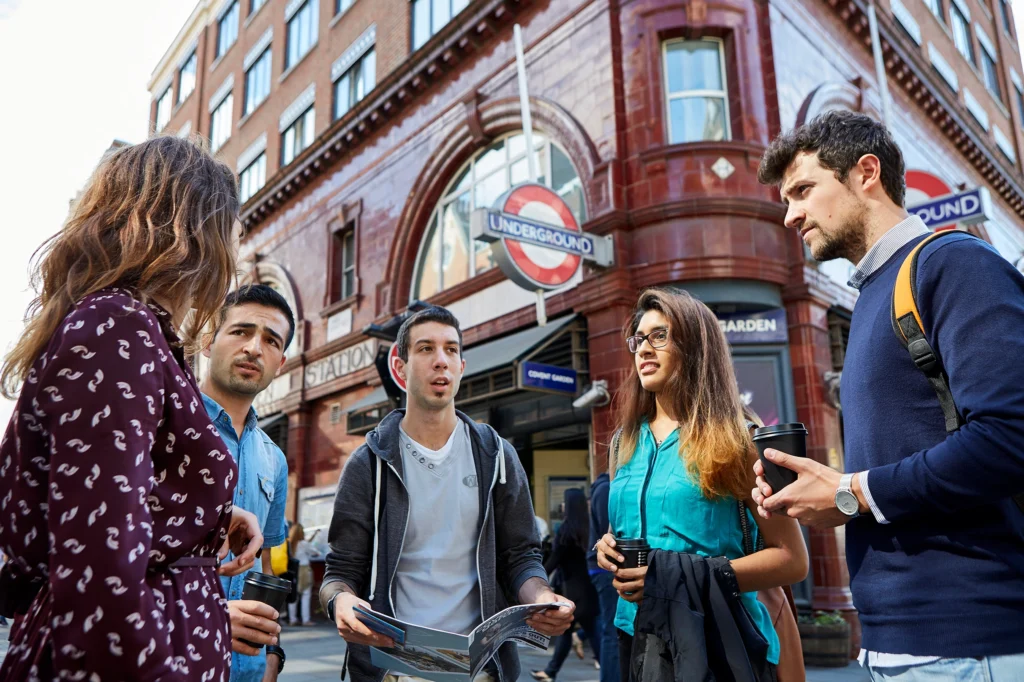 Students gathered in front of Covent Garden Tube Station.